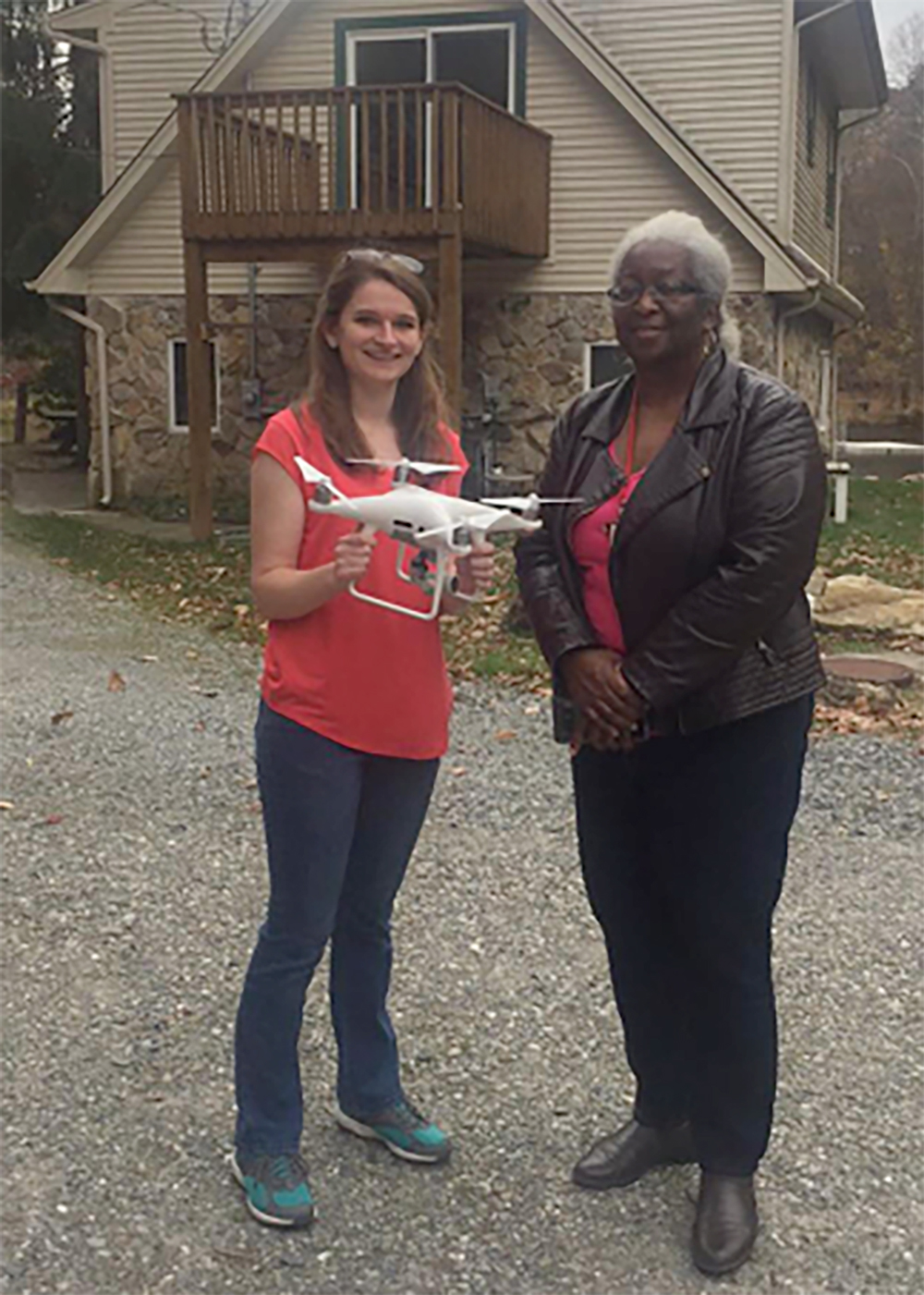Lauren holding the drone next to Dr. Amy Ferdinand