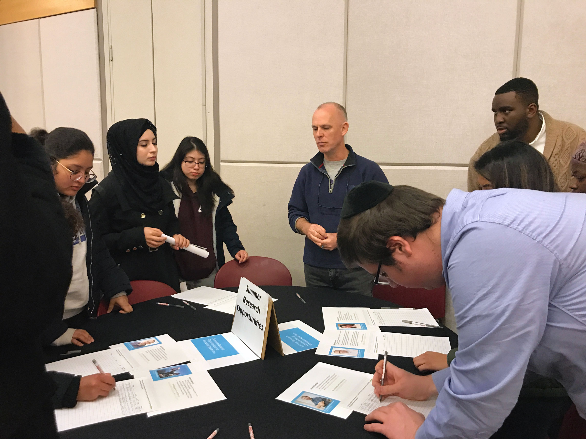 Students getting information about summer research opportunities.