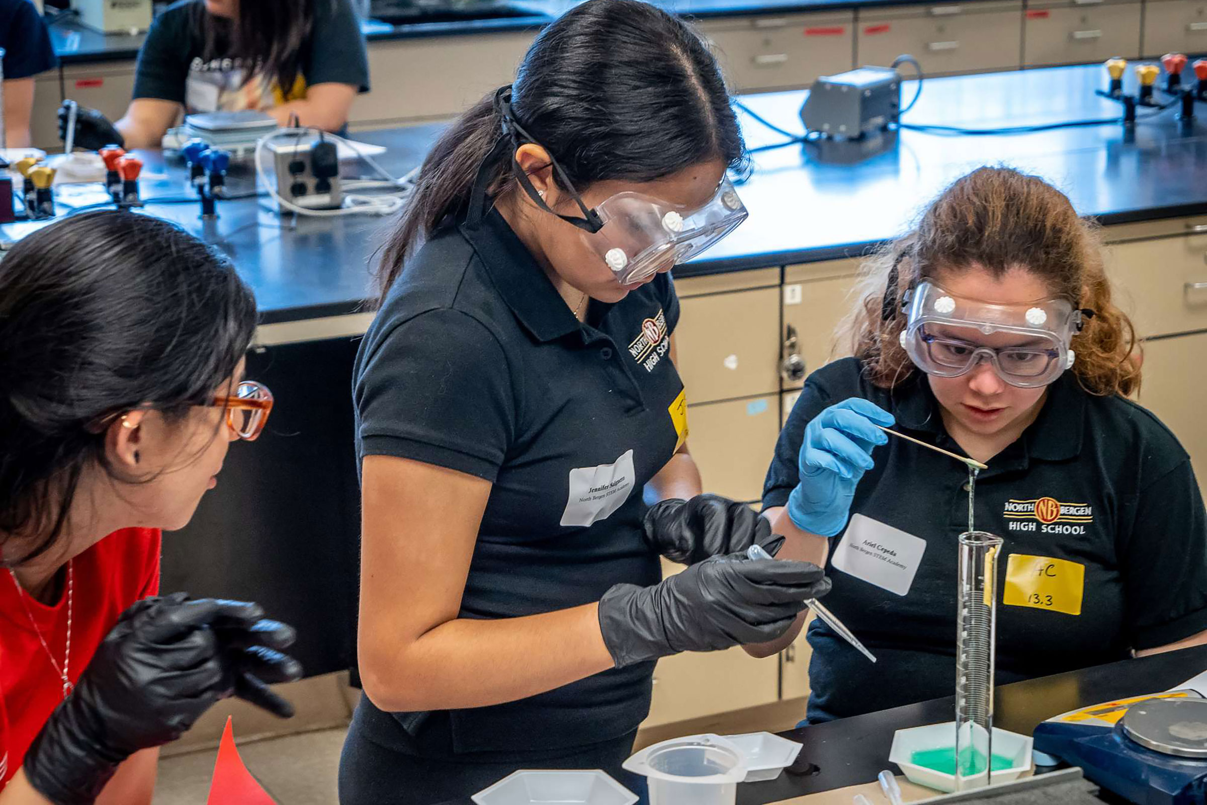 Students experiment with testing ratios of poly vinyl alcohol (PVA) and 8% Borax solution to make super slime with Chemistry and Biochemistry Professor Nina Goodey.