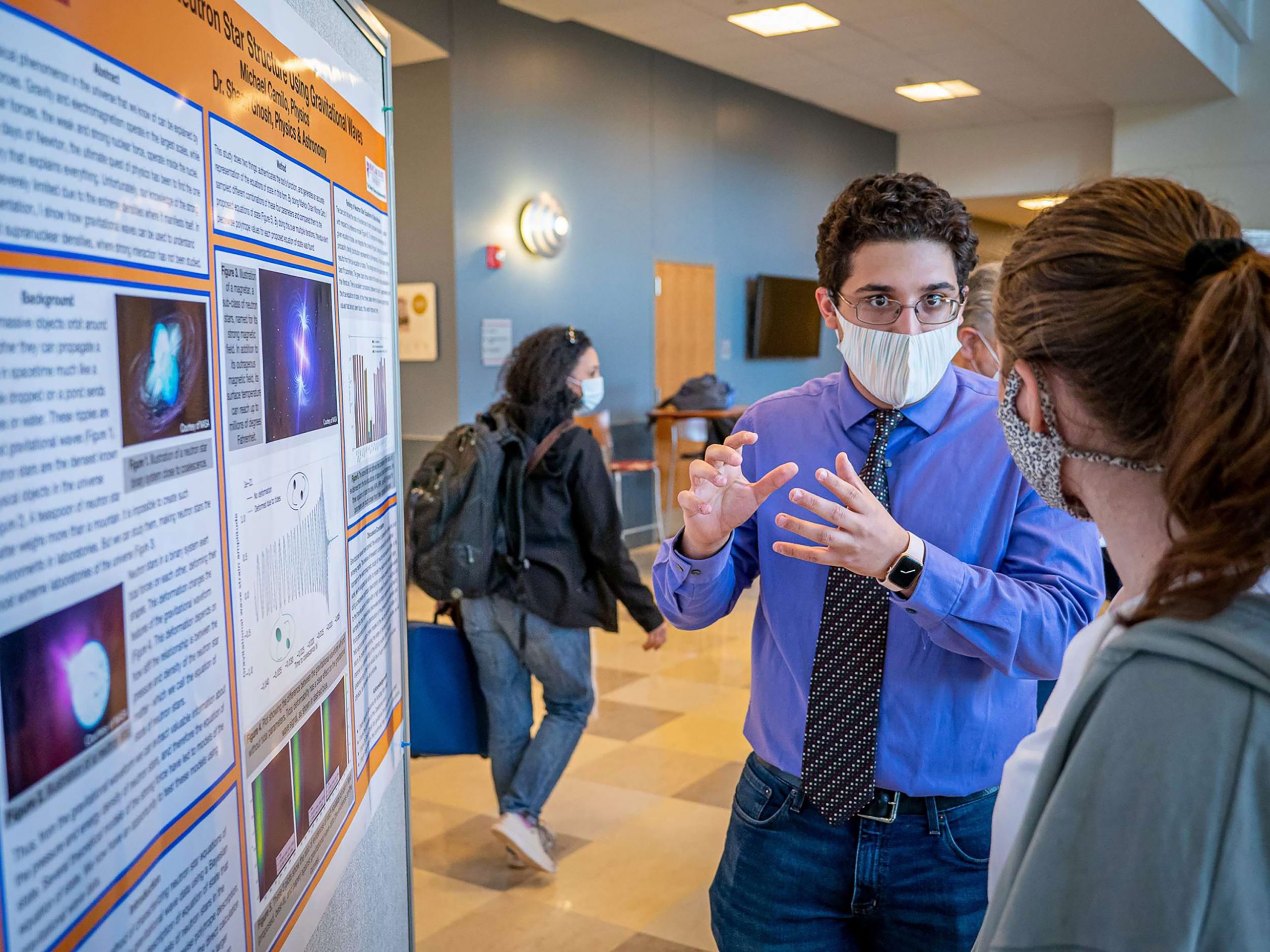 Michael Camilo explaining her research during the poster session