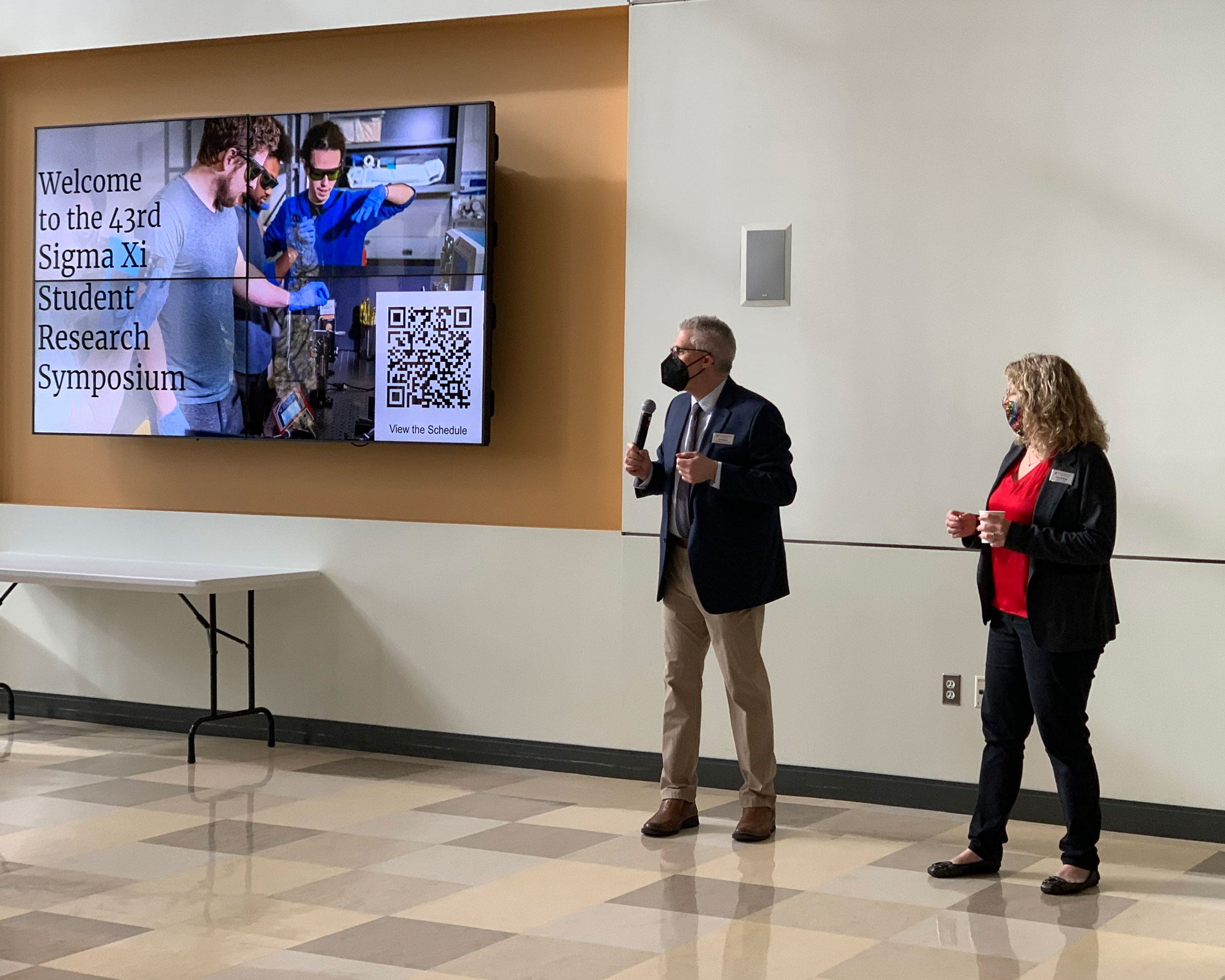 Associate Dean and Dean talking to attendees