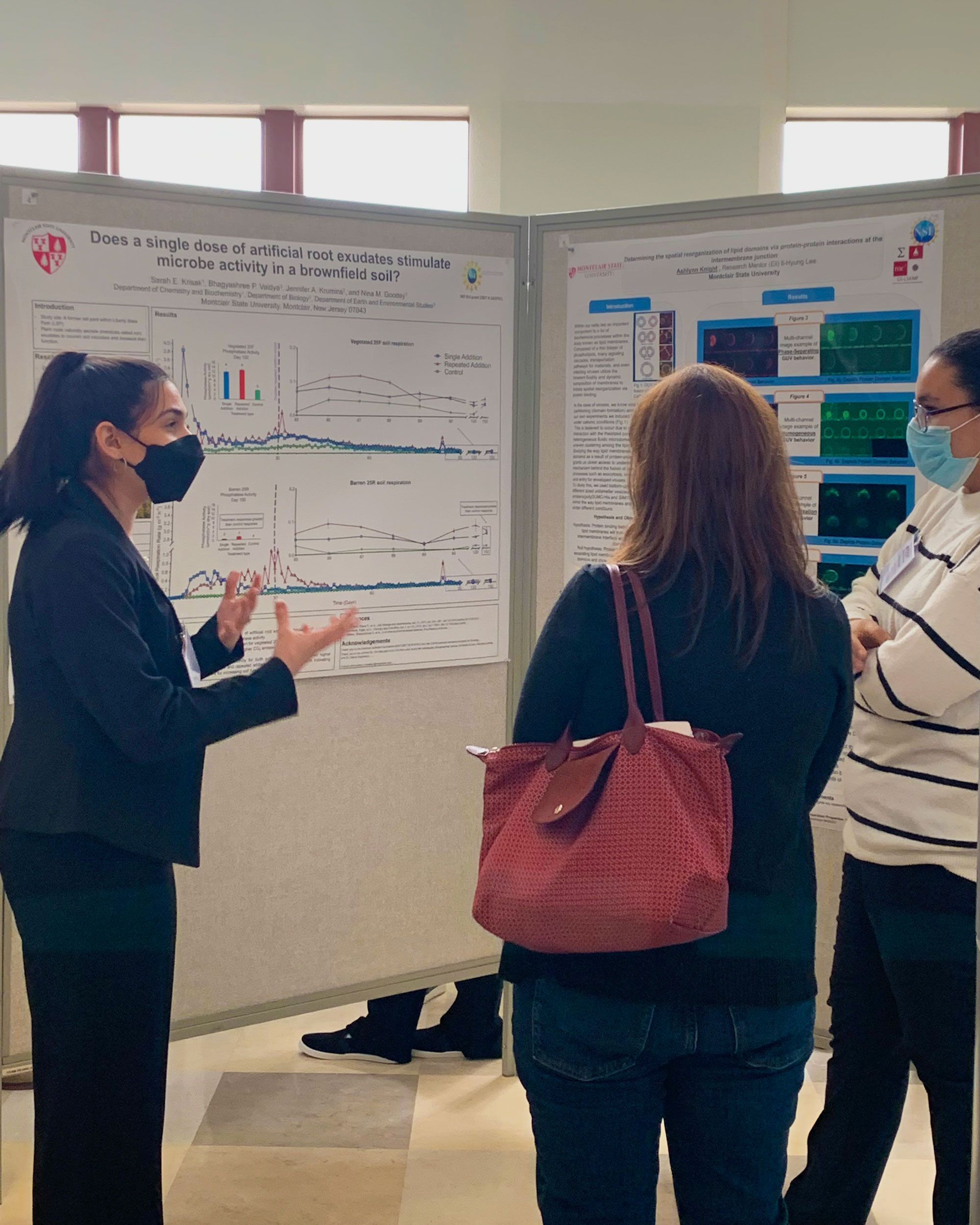 research student talking about research by poster