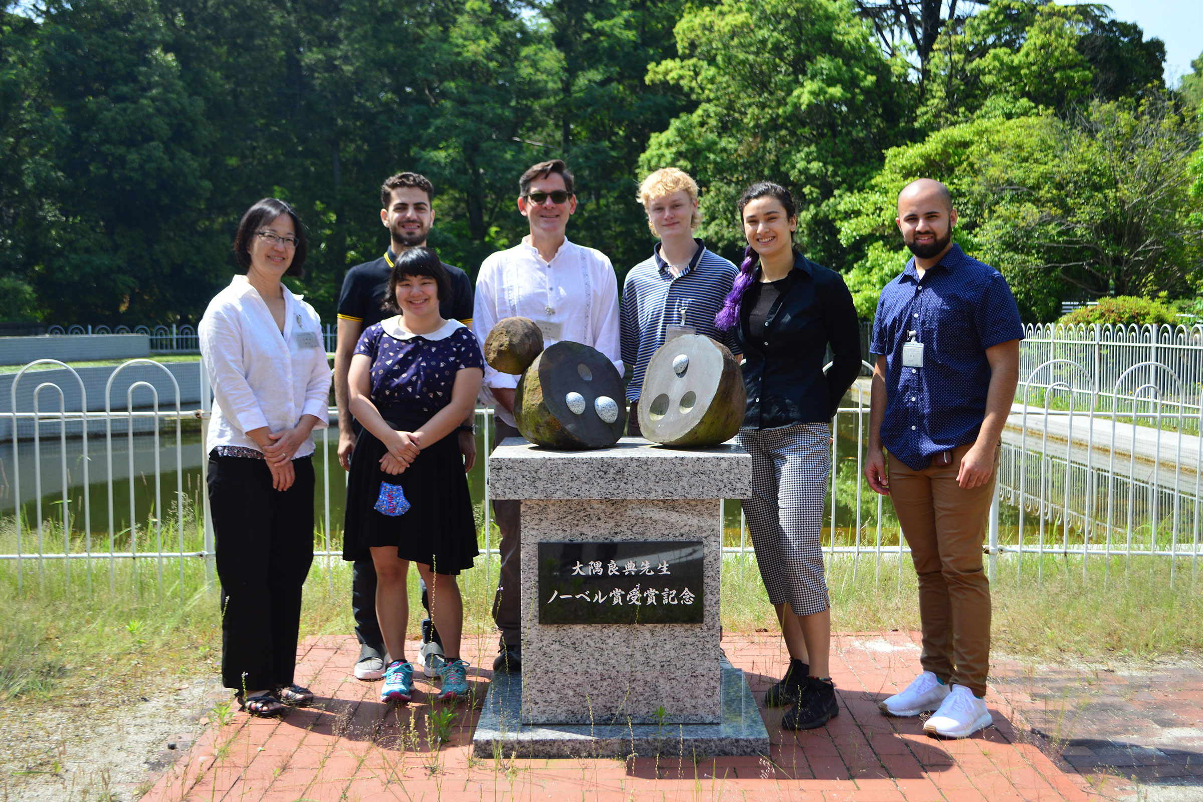 group photo around sculpture
