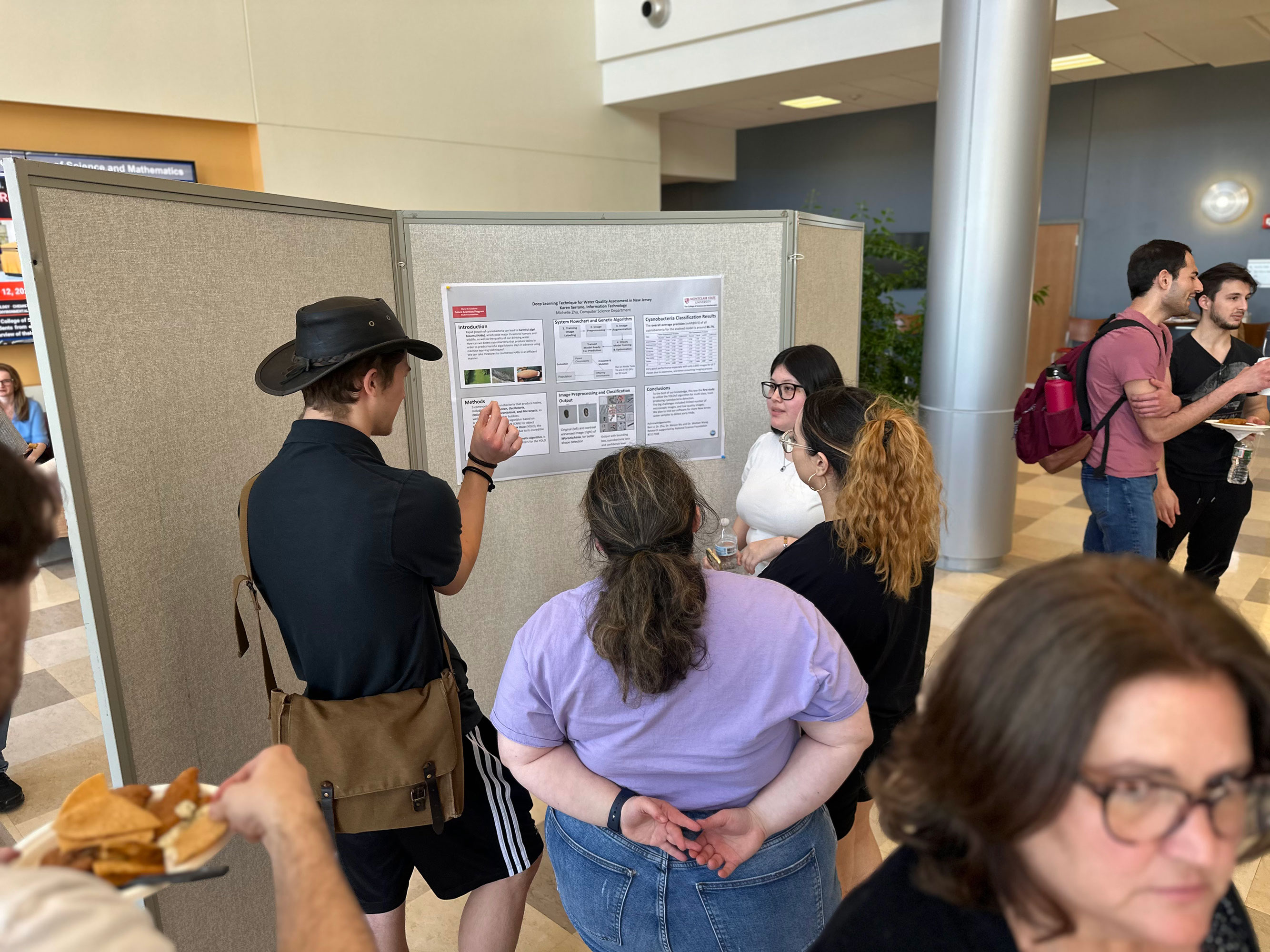 Karen Serrano discussing her poster with guests
