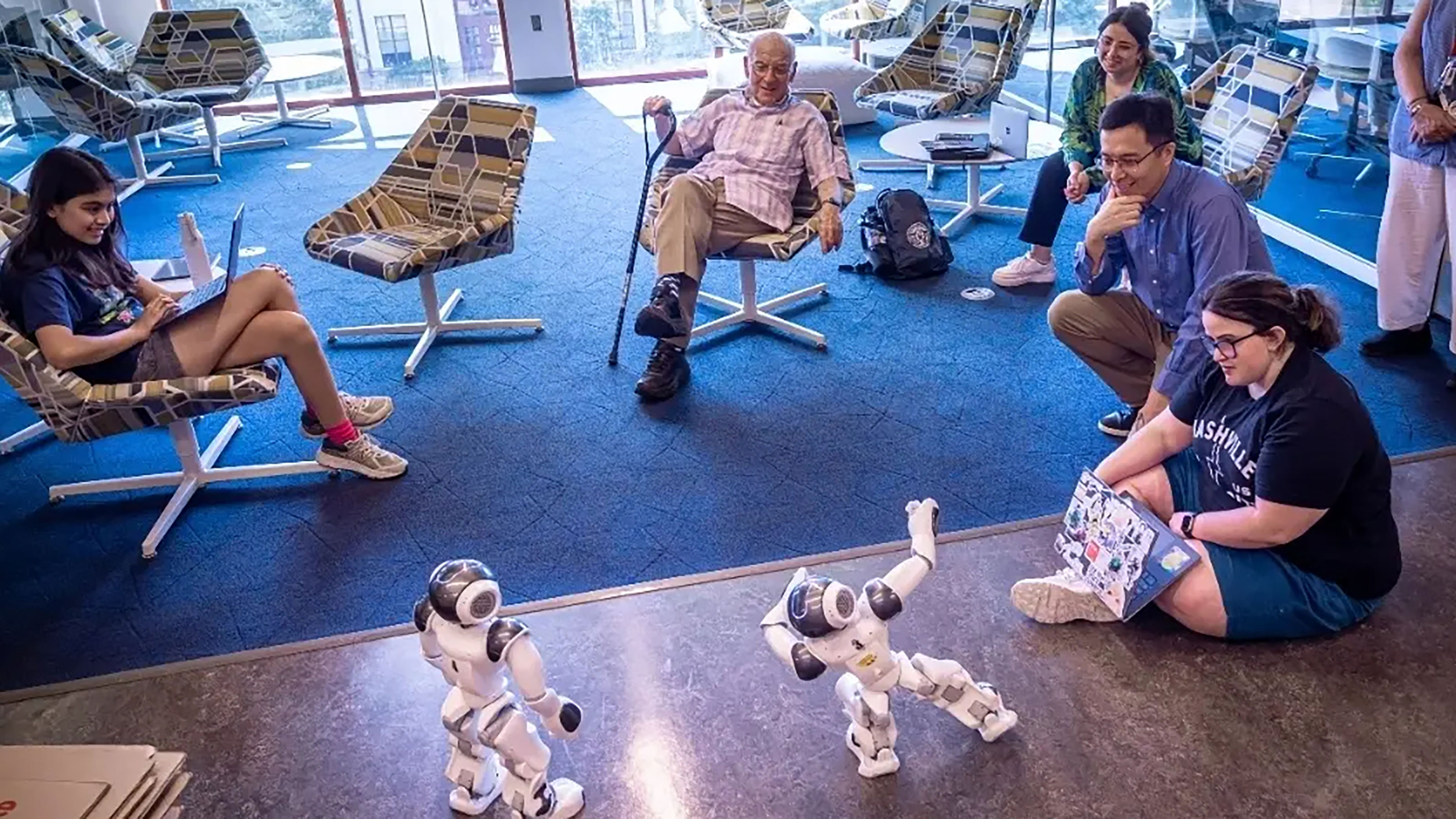 Josh Weston with Weston Scholars students demonstrating robots