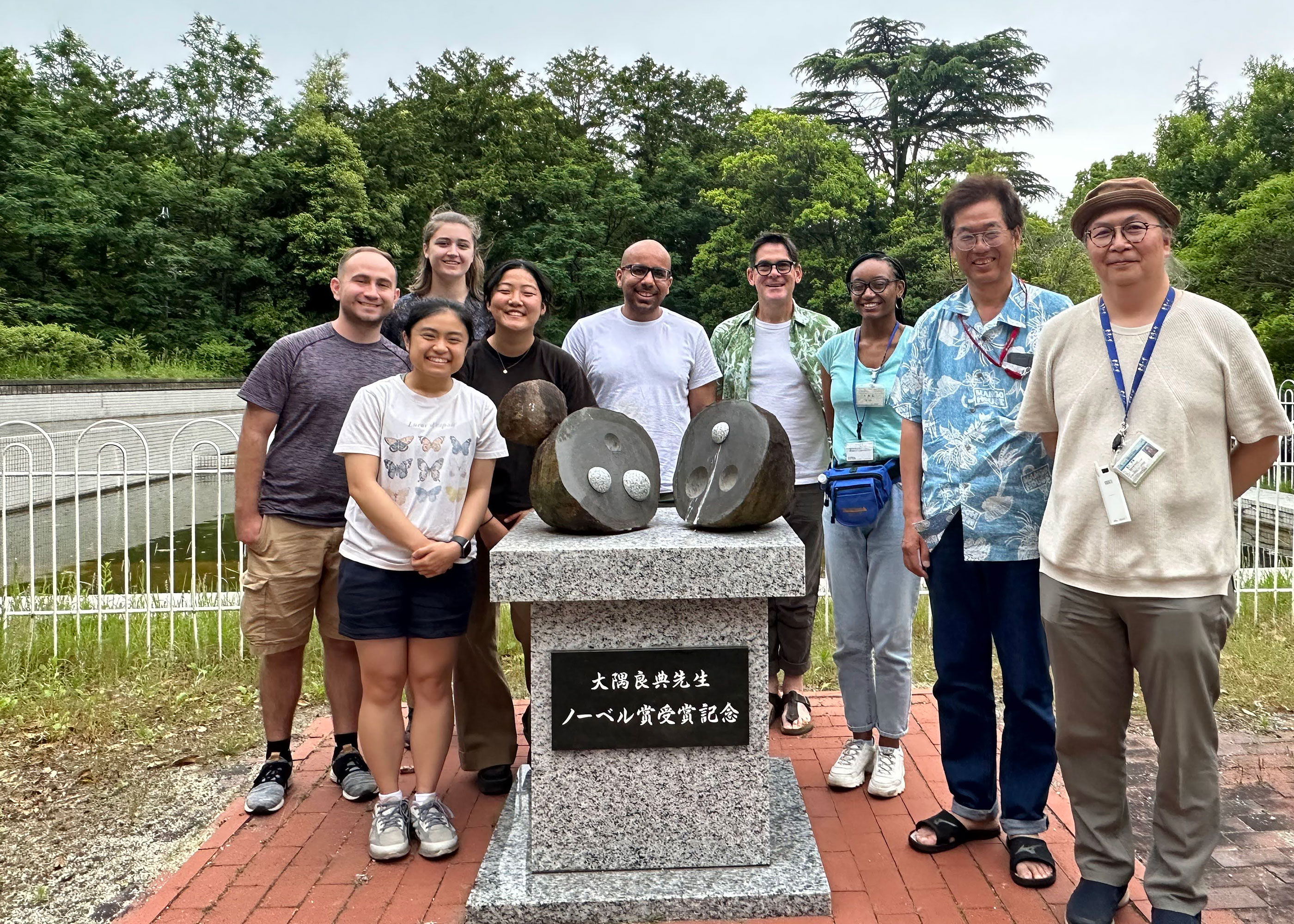 group in front of sculpture