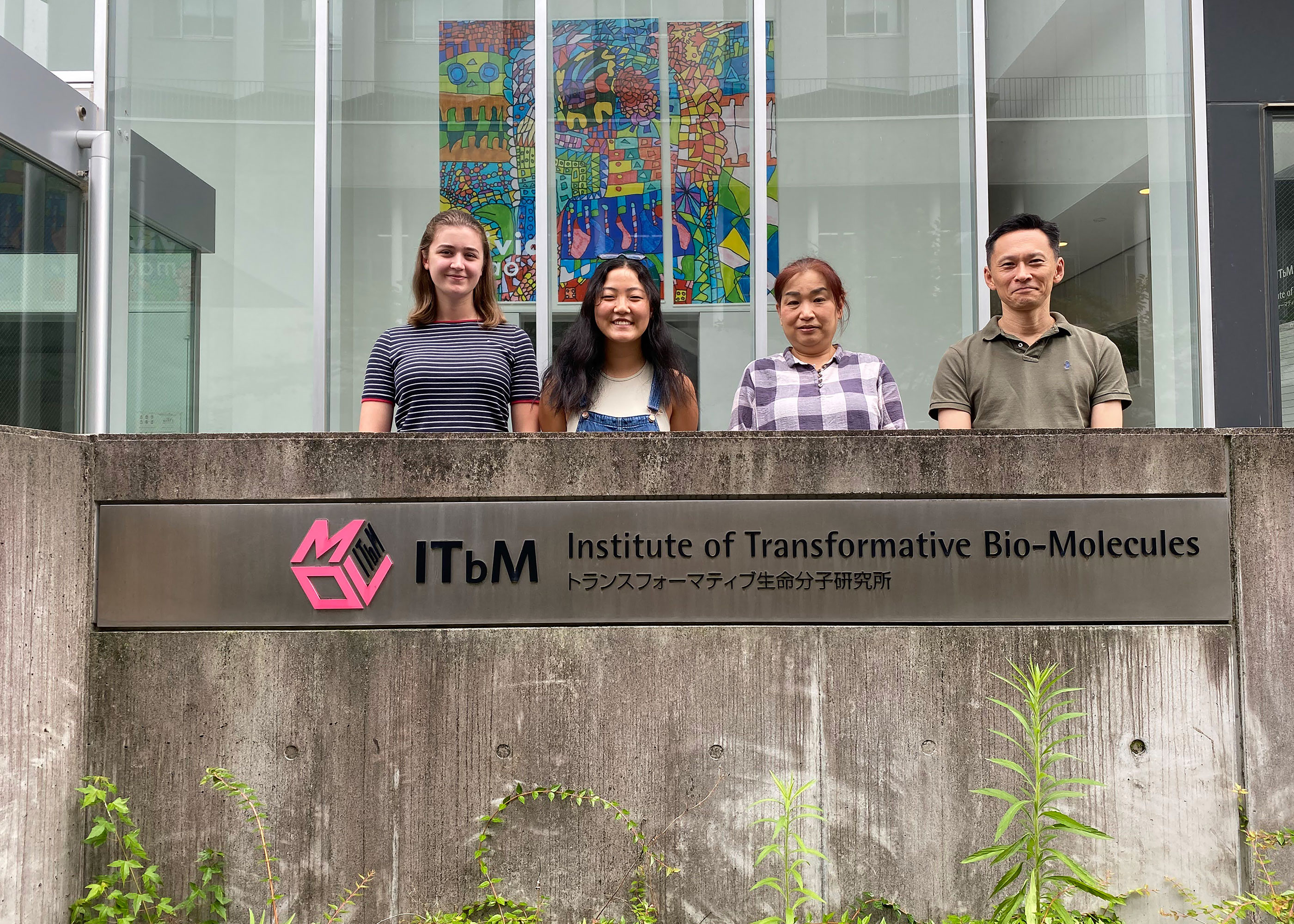 students and mentor by Institute of Transformative Bio-Molecules sign