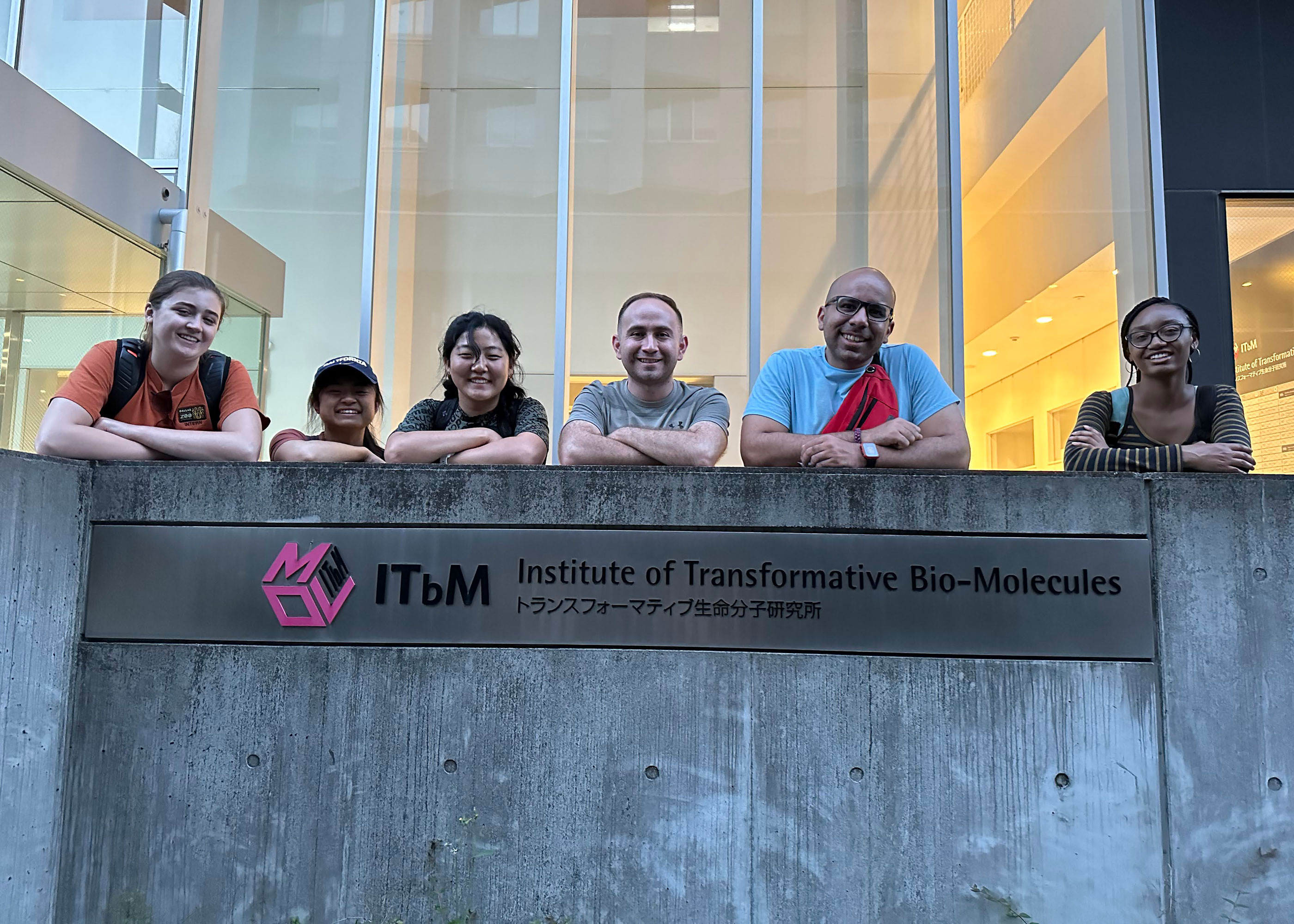 students and mentor by Institute of Transformative Bio-Molecules sign