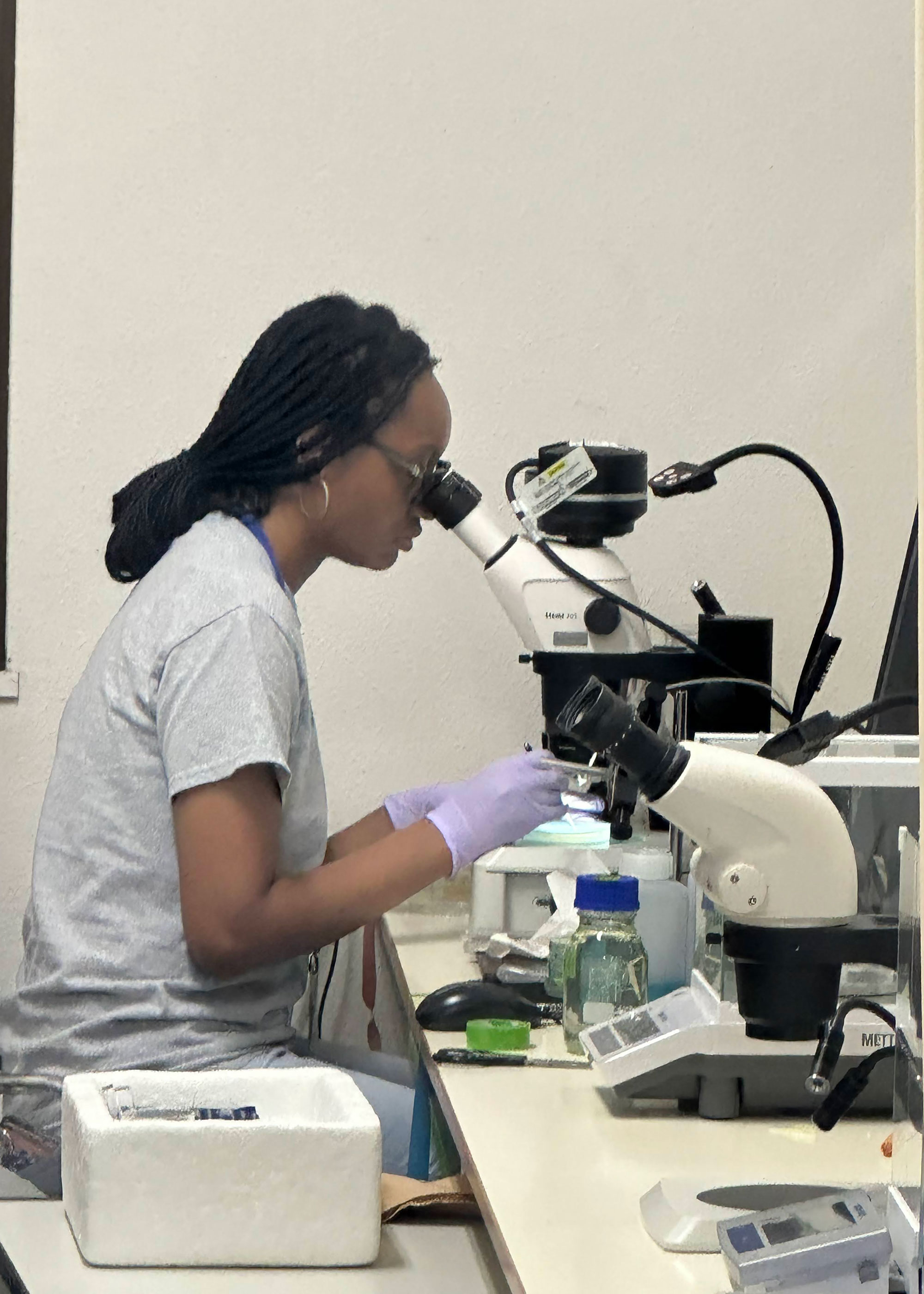 Talyia using microscope