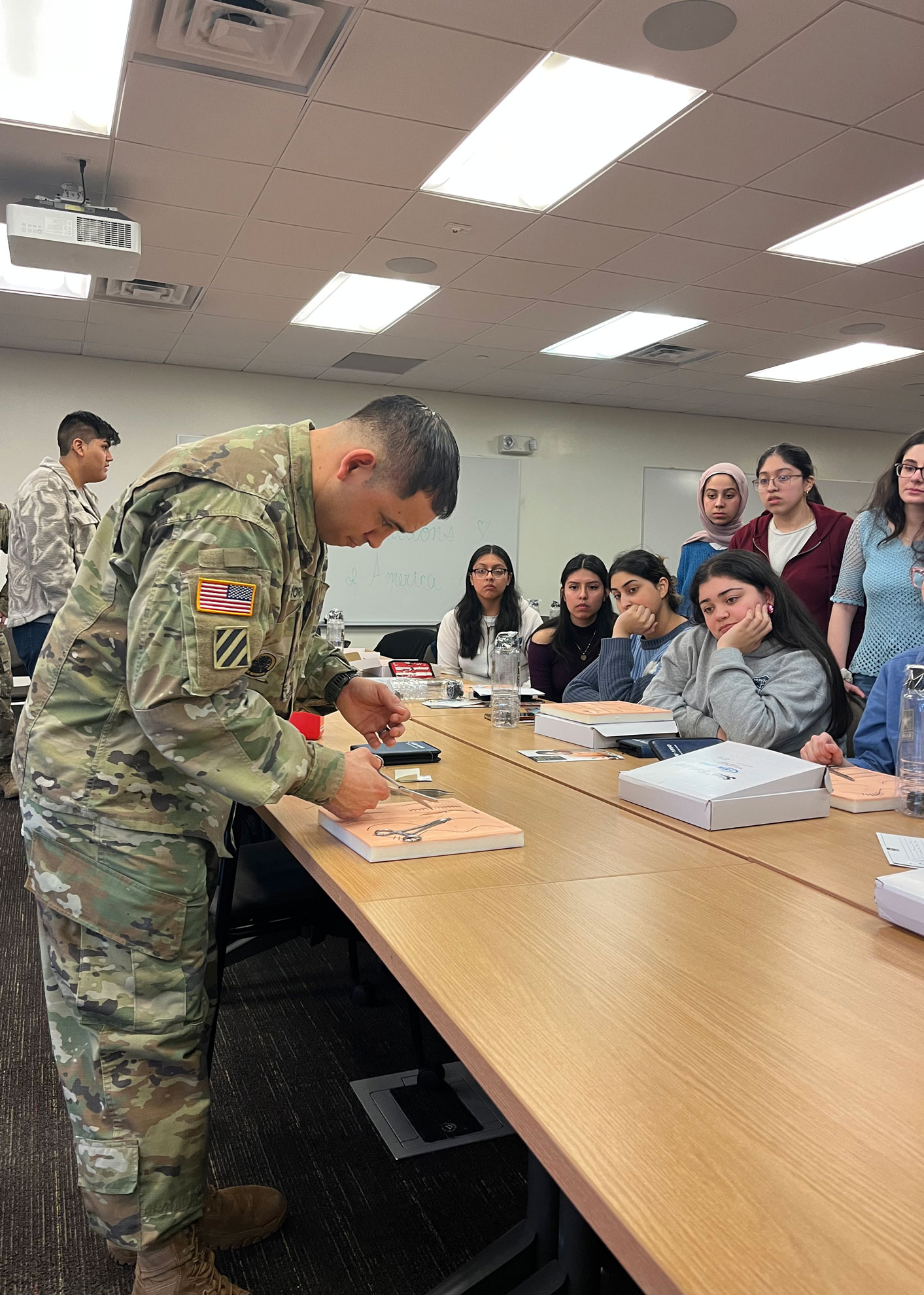 Sergeant Marco Borrego giving a suturing demonstration