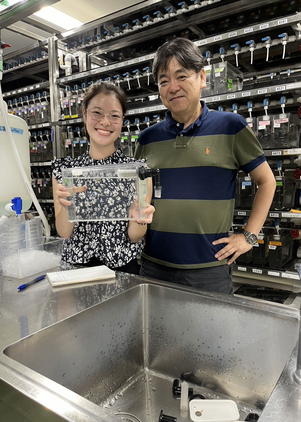 student with mentor in vivarium with water tank