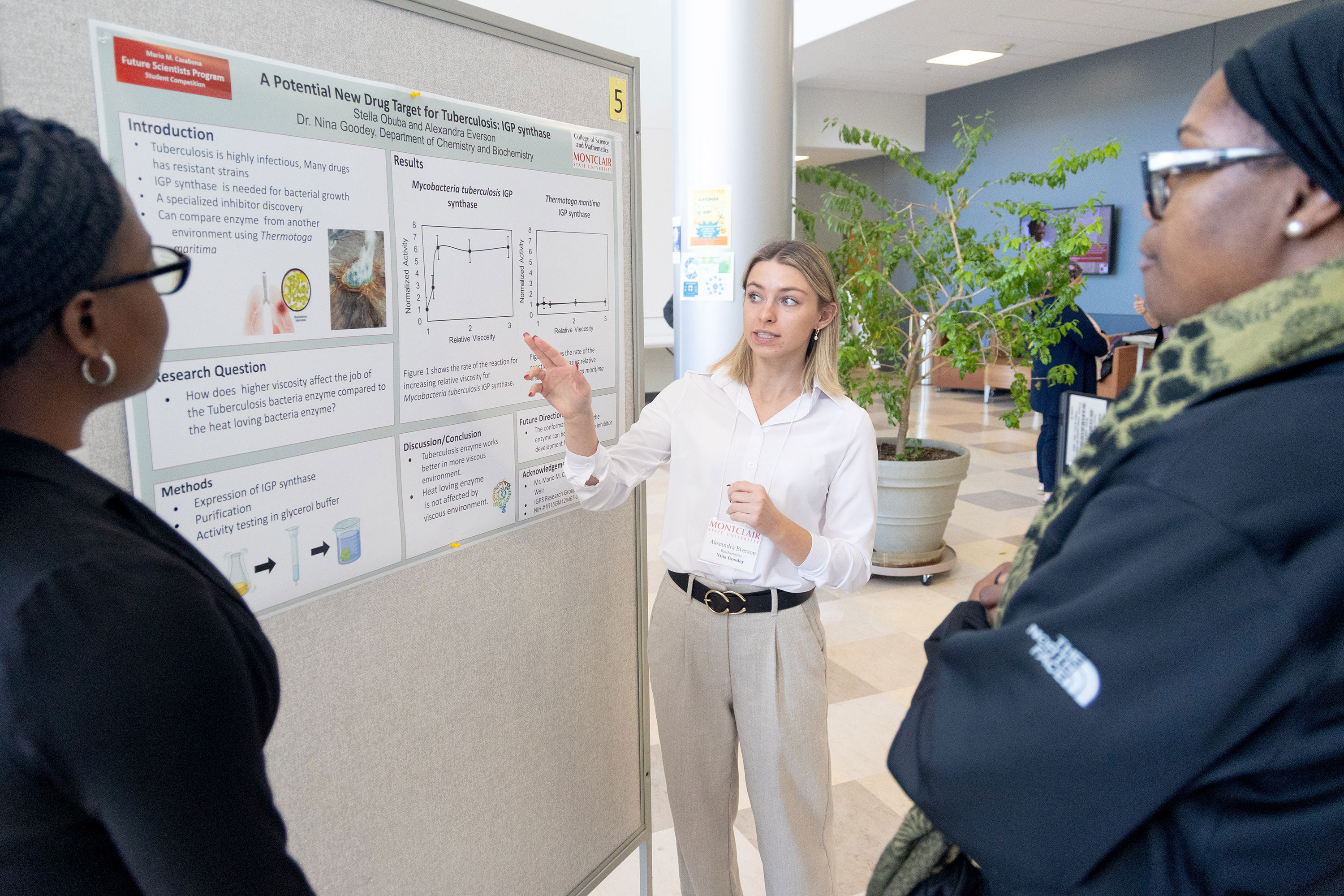 Stella Obuba and Alexandra Everson discuss their poster at the Fall 2024 Casabona Competition