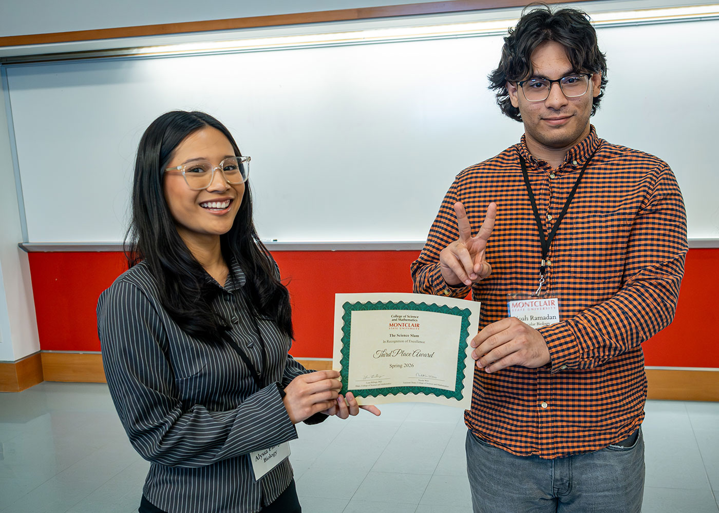 Noah Ramadan and Alyssa Paragas with their third place award at the Science Slam