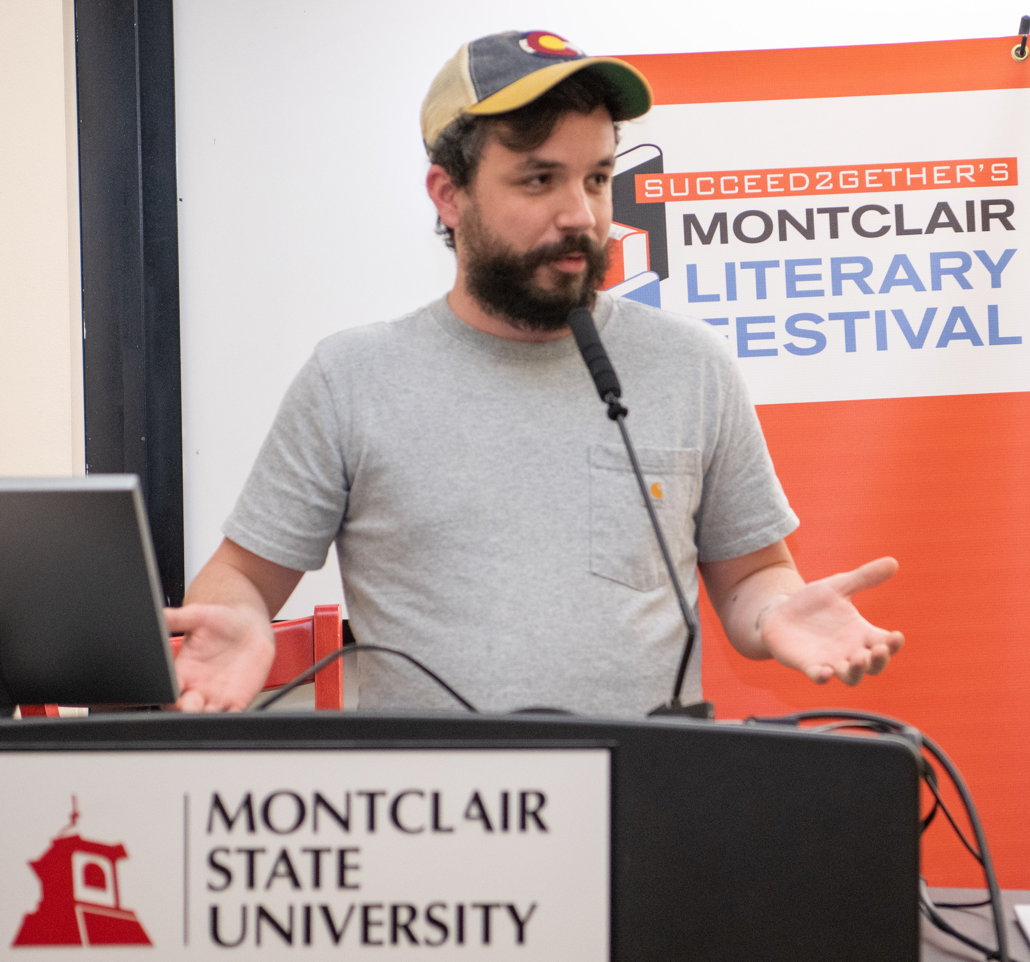 photo of student Caleb Knight speaking while standing behind a podium