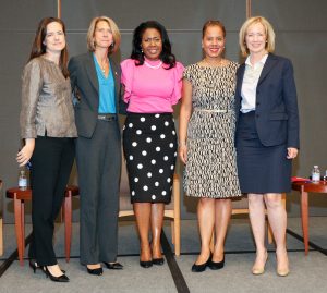 Five women standing on stage.