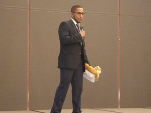 Student holding prototype slippers.