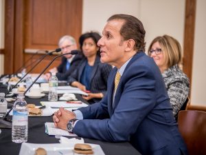 Photo of four judges, seated, at microphones.