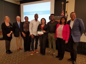 Crowd of people with Olivia Hettman in center.