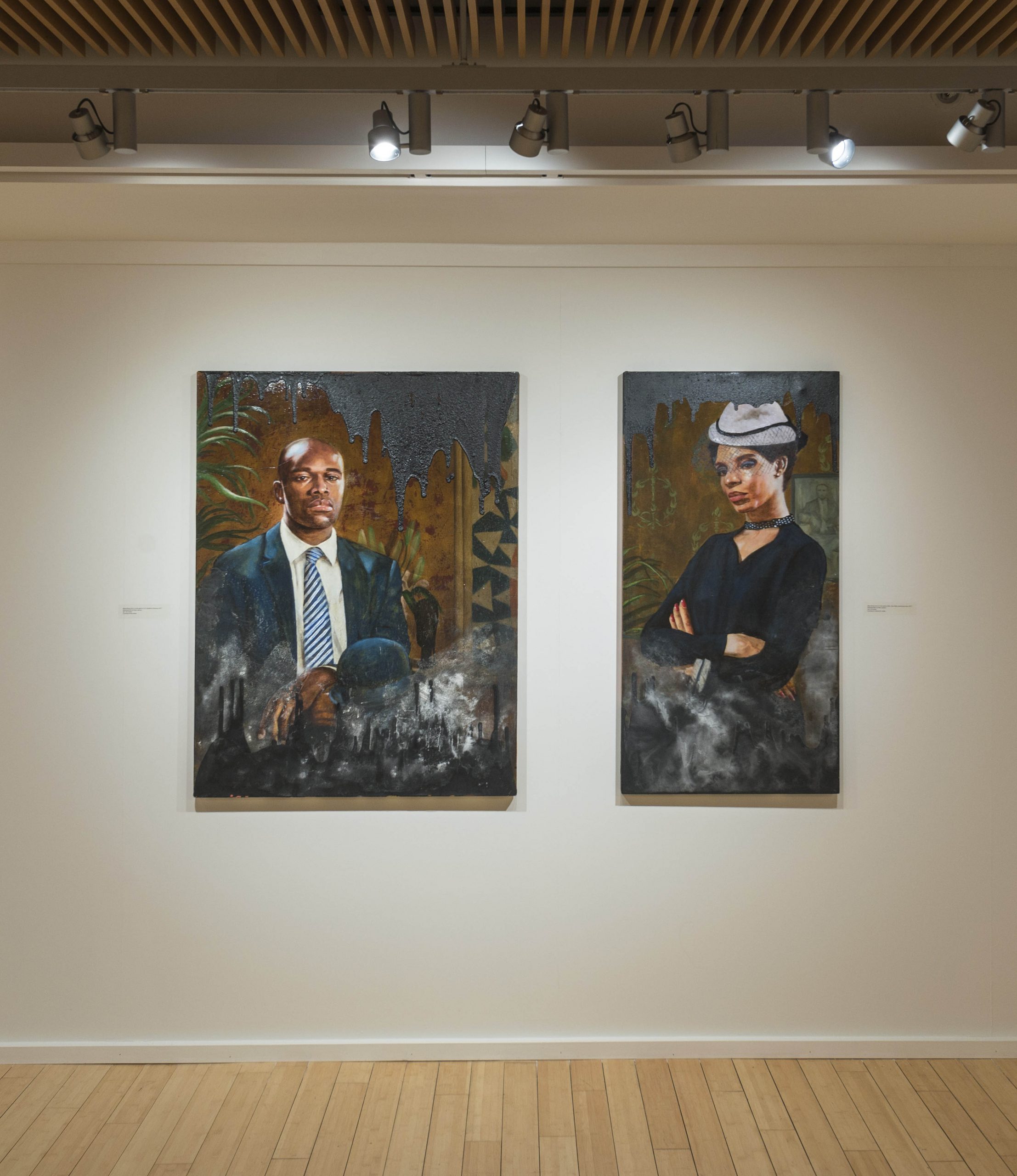 Installation photography in the George Segal Gallery of two paintings on view in the University Galleries' spring 2022 exhibition, Ajamu Kojo's "Black Wall Street: A Case for Reparations"