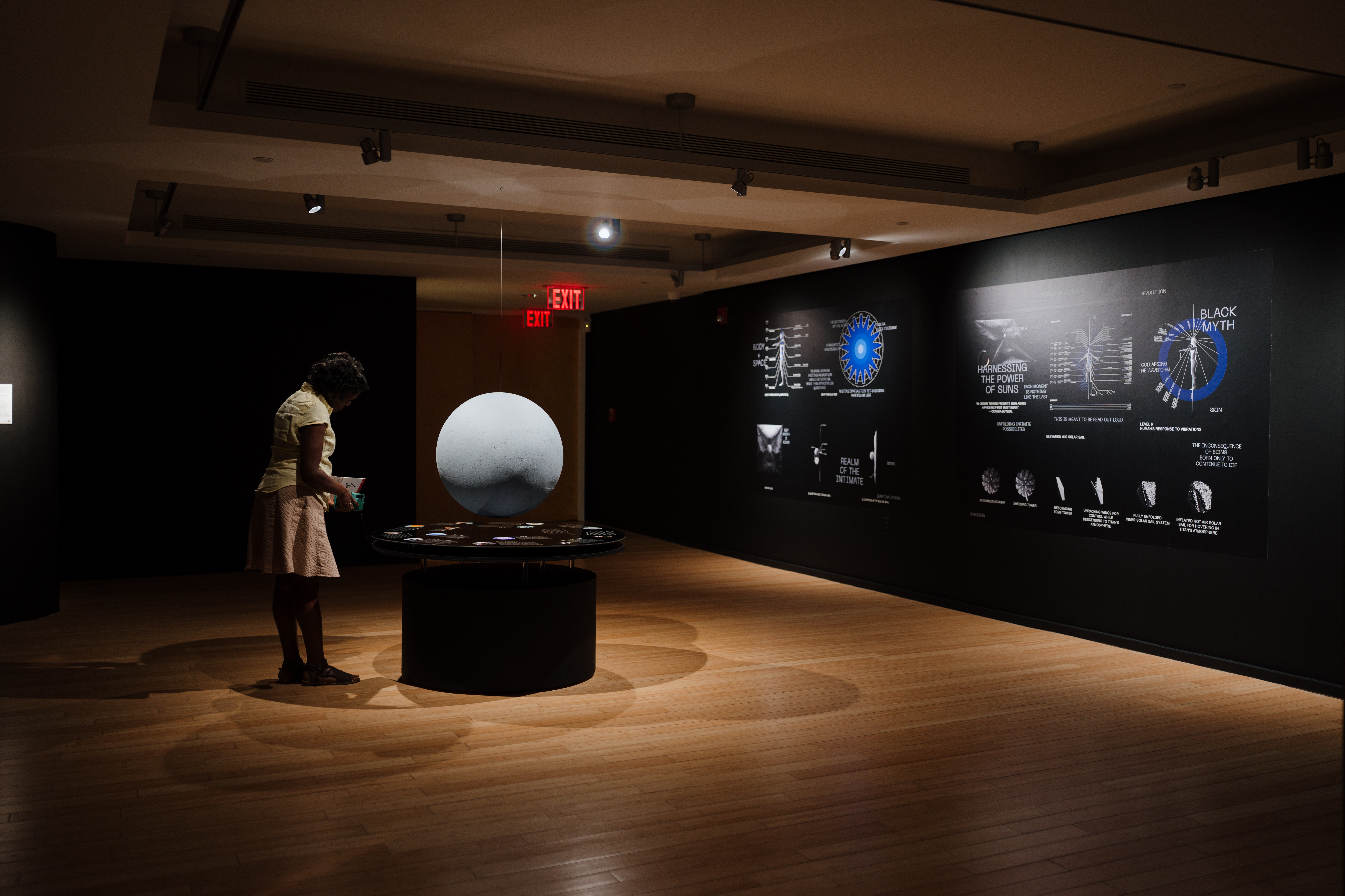 A visitor stands and observes an installation in the exhibition.