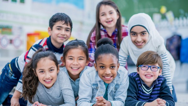 photo of a group of diverse, young children smiling in a group photo