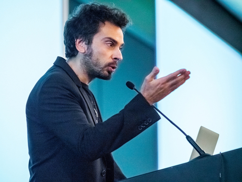 Man at lectern speaking