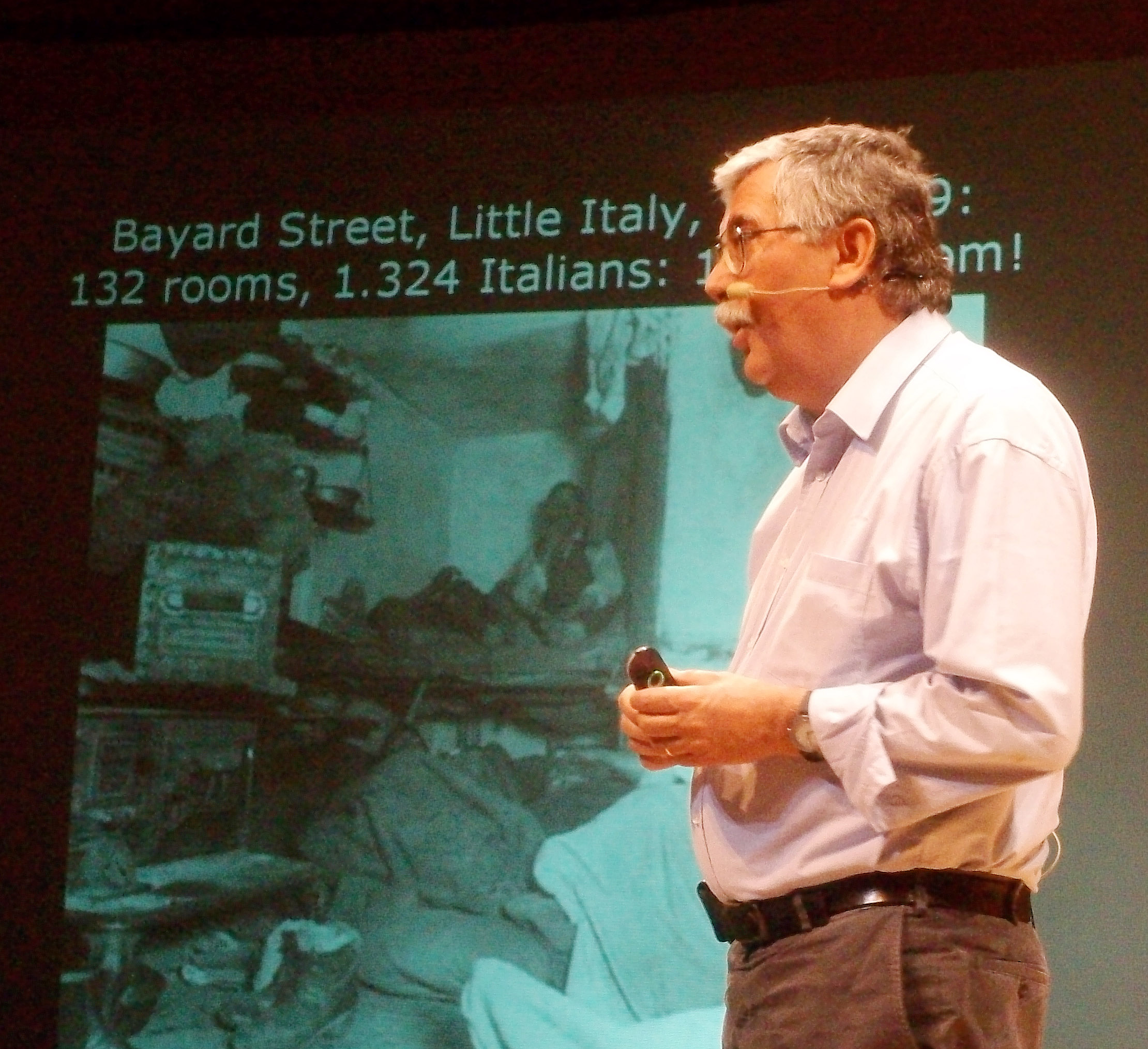 Man on stage giving presentation