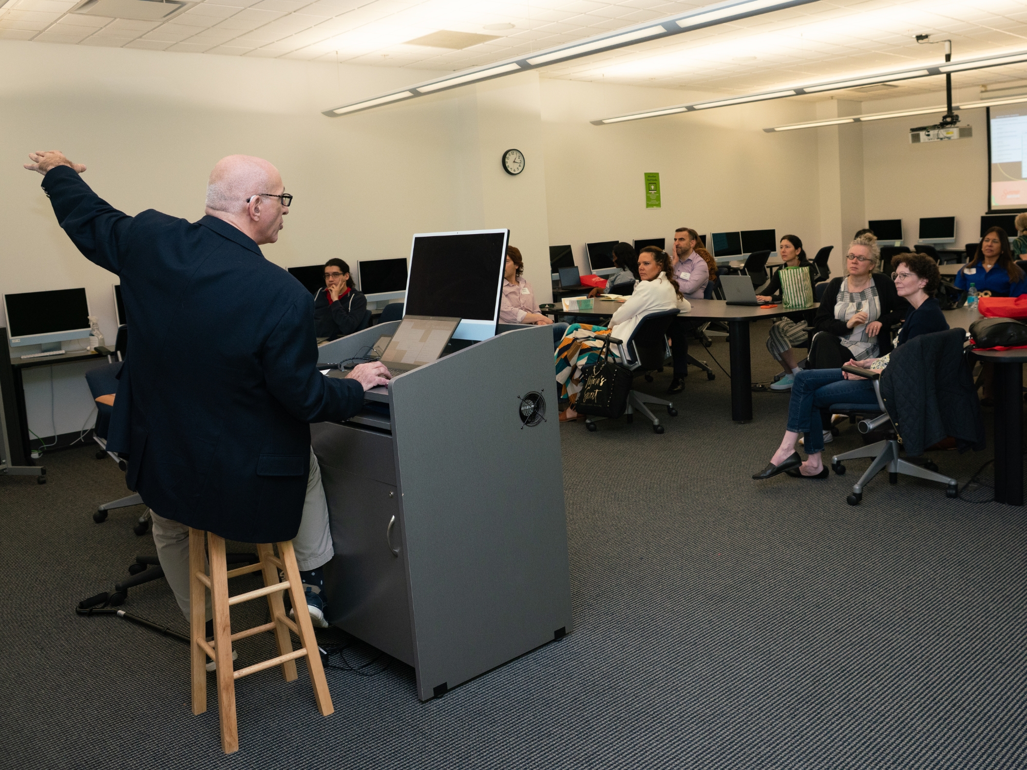 Man presenting in a workshop of people.
