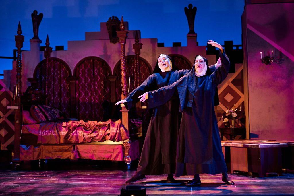 Two nuns on stage in dramatic pose