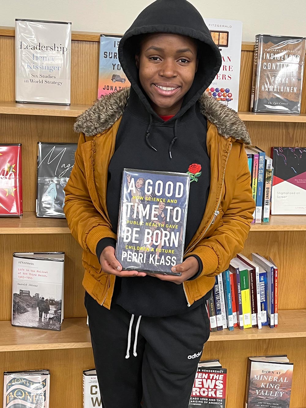 Jennifer Asamoah holding the book A Good Time to be Born