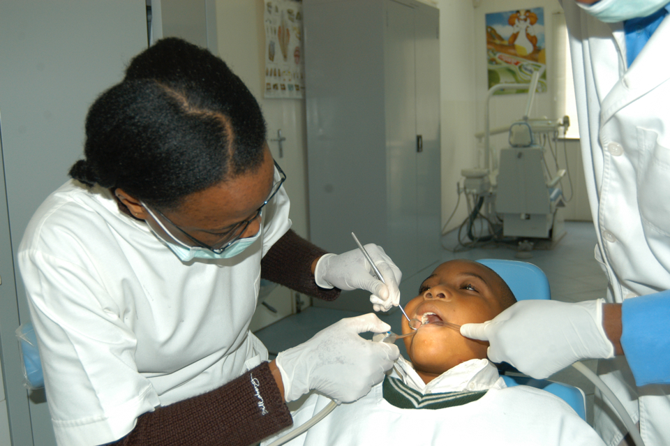 Fernanda Andre, dentist, attending to a small child in Mozambique.
