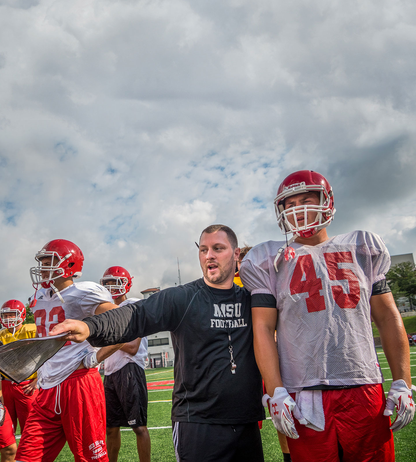 Assistant Coach Mike Palazzo instructing a Montclair State University football player.