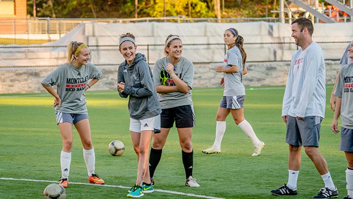 Kim Mignone (second from left) inspires her teammates to win without her.