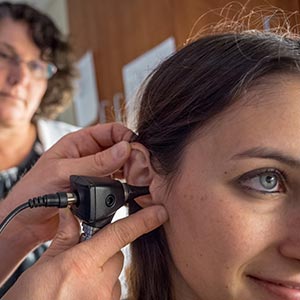 Patient being examined with otoscope.