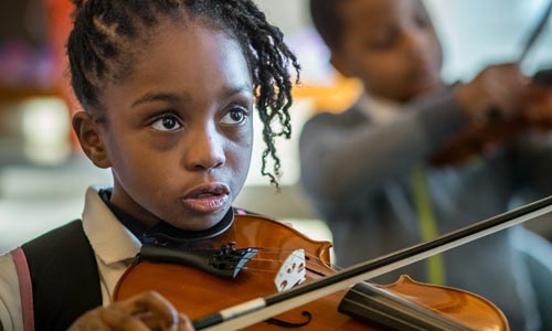 Photo of elementary school student playing violin