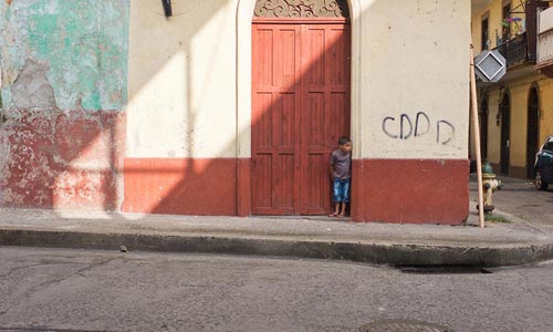 Photo of a boy standing in a doorway