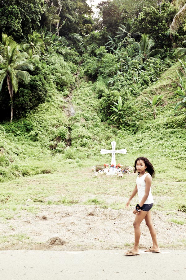 Photo of a child walking past a memorial
