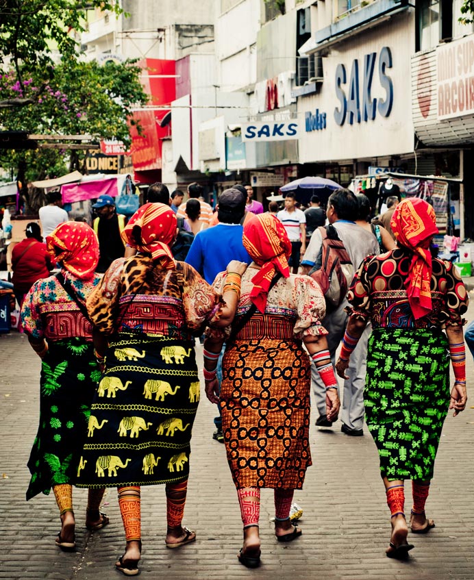 Photo of women walking down the street lined with shops