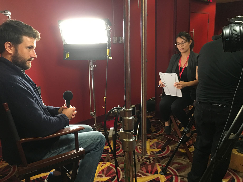 Photo of Craig Shilowich, screenwriter/producer of Christine being interviewed by student Melanie St. Clair