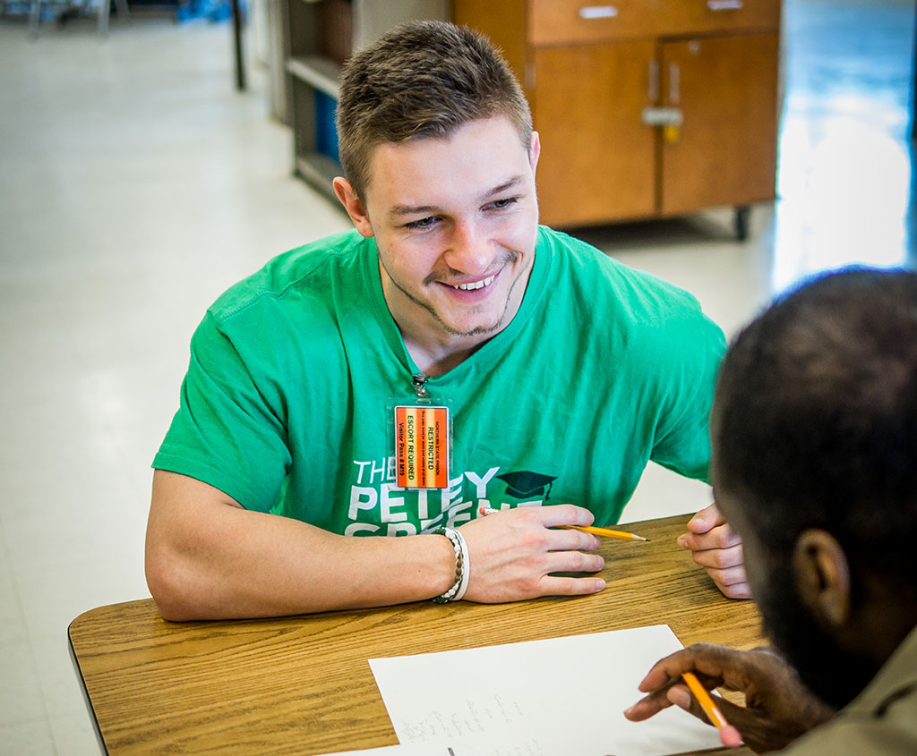 Senior Joe Wasowski tutoring prisoner.