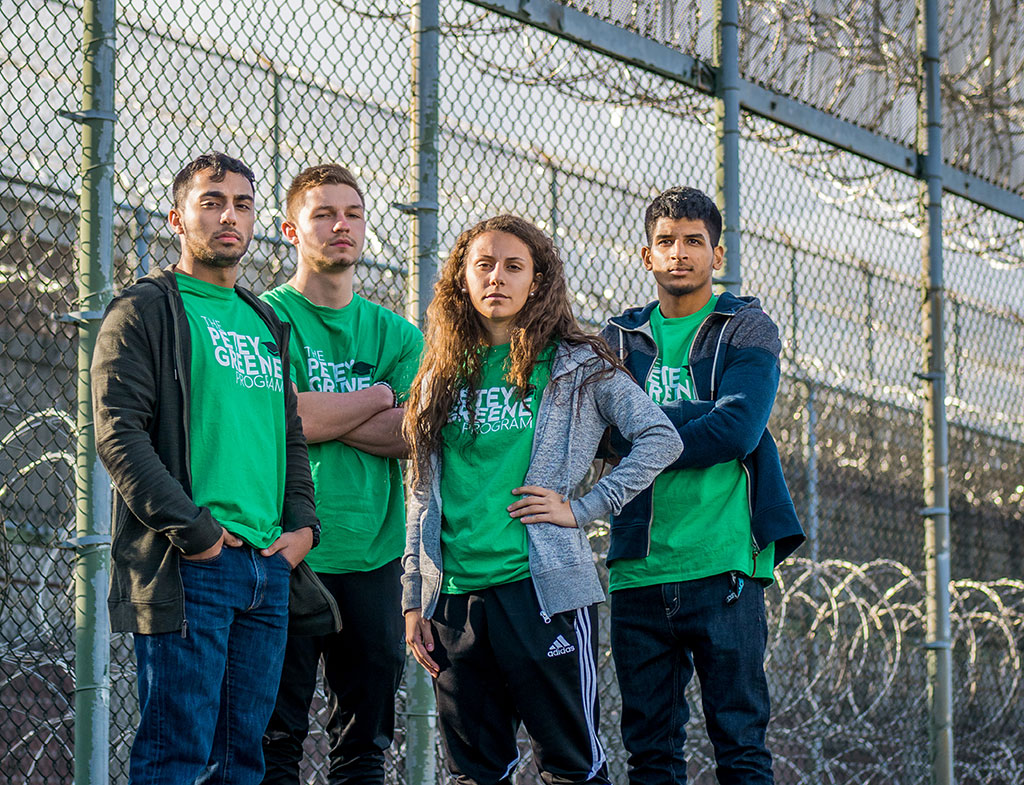 Munajj Khan, Joe Wasowski, Koedi Shakir and Paramvir Singh standing in front of prison.