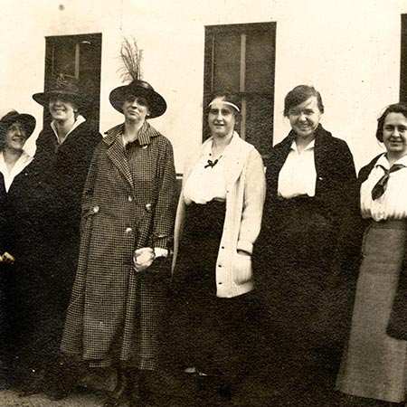 Six women standing in front of Russ Hall in 1918.