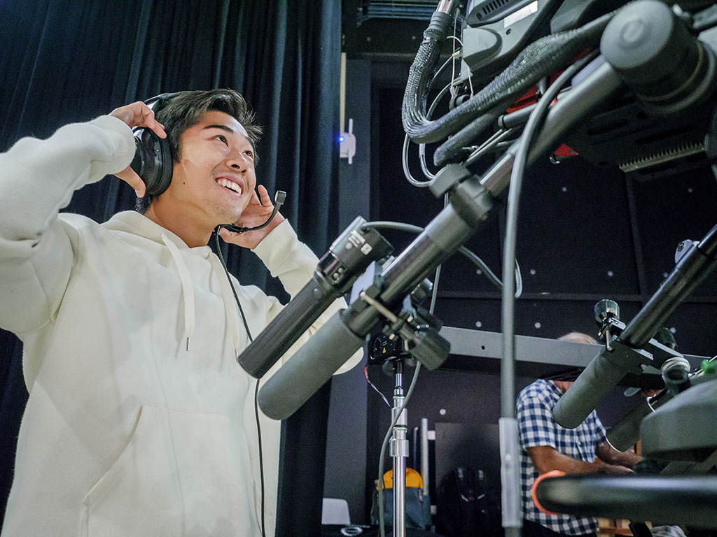 Student Alex Chen runs the camera during a taping of Carpe Diem.