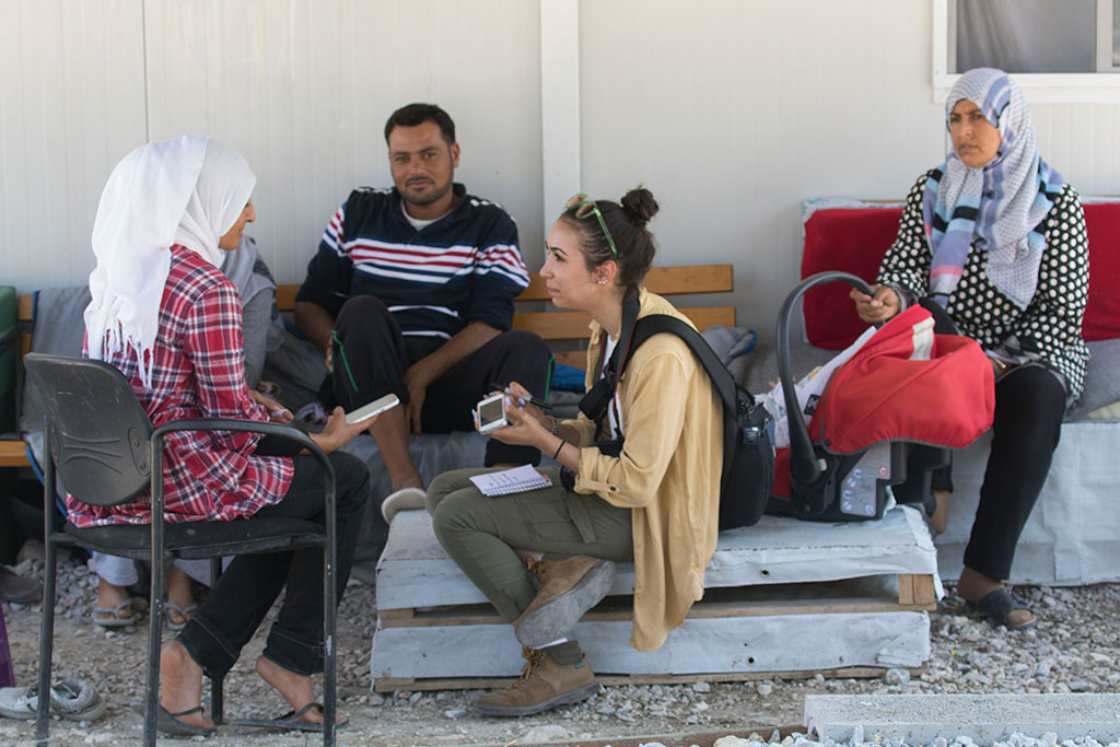 Danielle Weidner interviews a young Syrian woman and her family outside their trailer at the Kara Tepe camp in Lesbos.