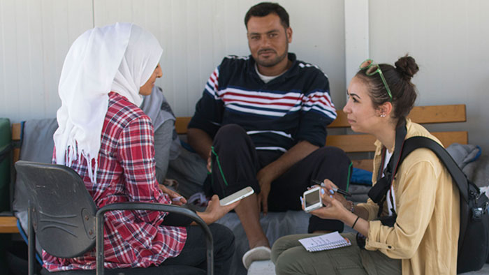 Student interviewing refugees in Greece.