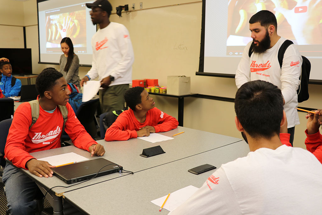 Boys listen as Saul Ocasio goes over a math lesson.