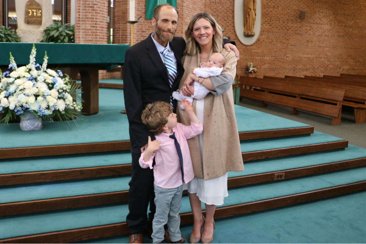 Mike Schambach coaches Montclair State men’s lacrosse; with his wife, Lindsay, son, Cameron, and daughter, Chloe, at the baby’s christening.