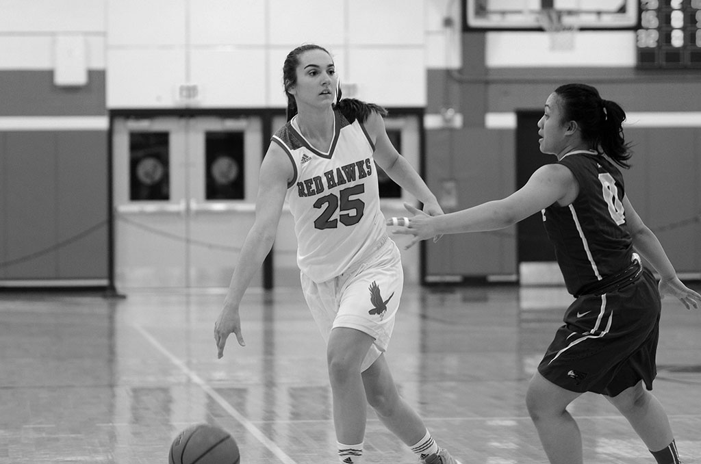 Coach Karin Harvey discusses strategy with the team during the last game of a building season.