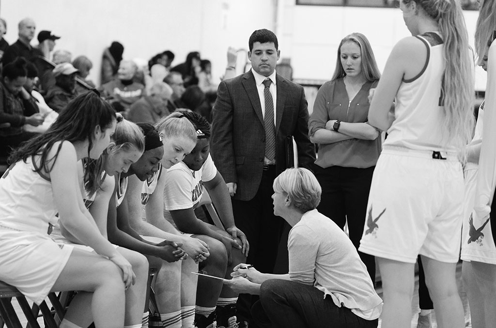 Coach Karin Harvey discusses strategy with the team during the last game of a building season.