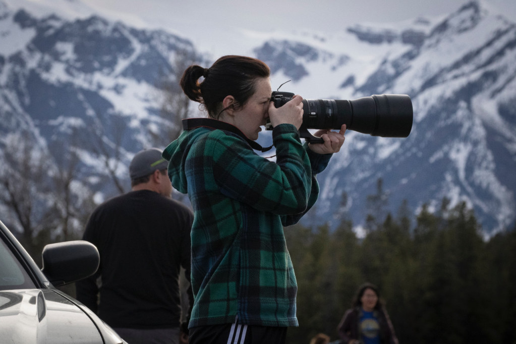 Geology student taking pictures with camera.